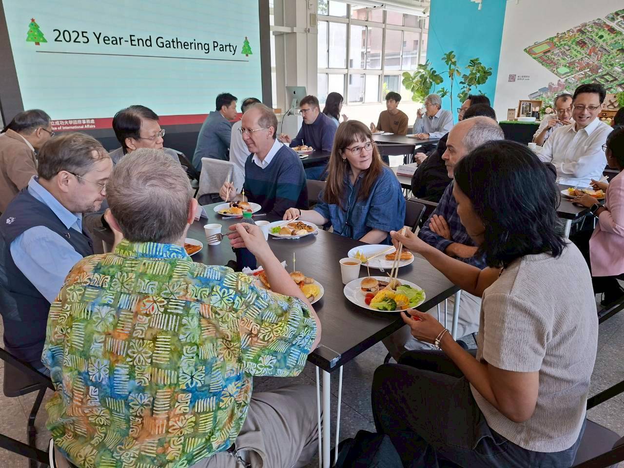   Participants share food, stories, and laughter at a cheerful year-end luncheon.