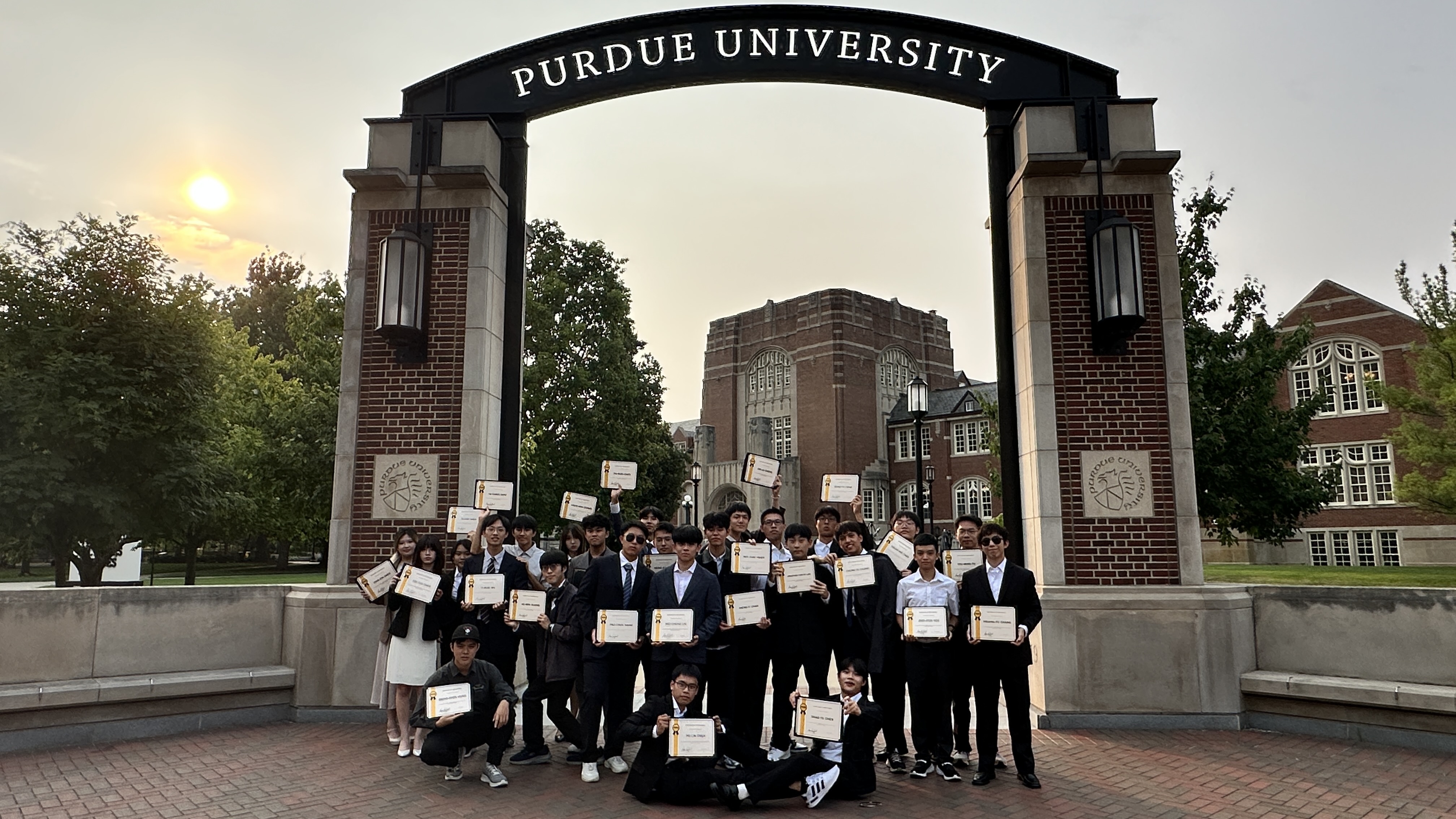 Group Photo in Front of Purdue University’s Main Entrance After the Closing Ceremony